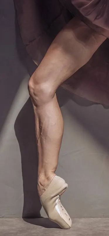 Close-up of Zuza's foot on pointe under a flowing skirt